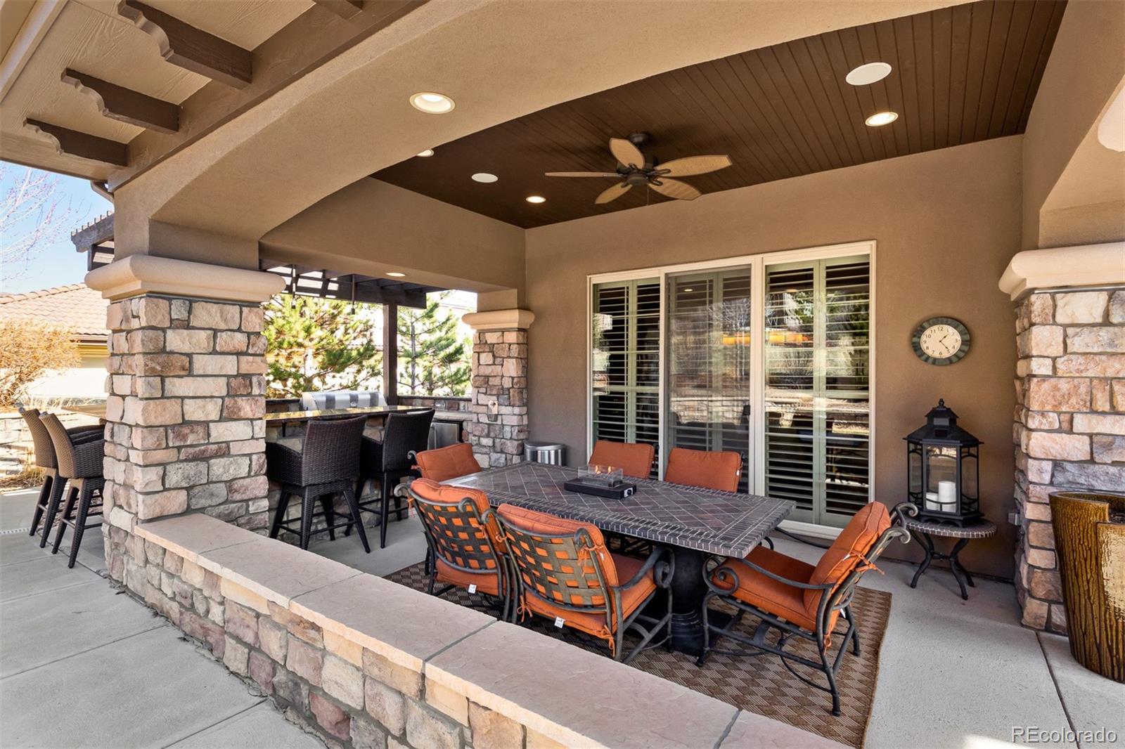 981 Buffalo Ridge Road Castle Pines, CO 80108 - Photo 32 of 39 an outdoor sitting area with couch and wooden shade