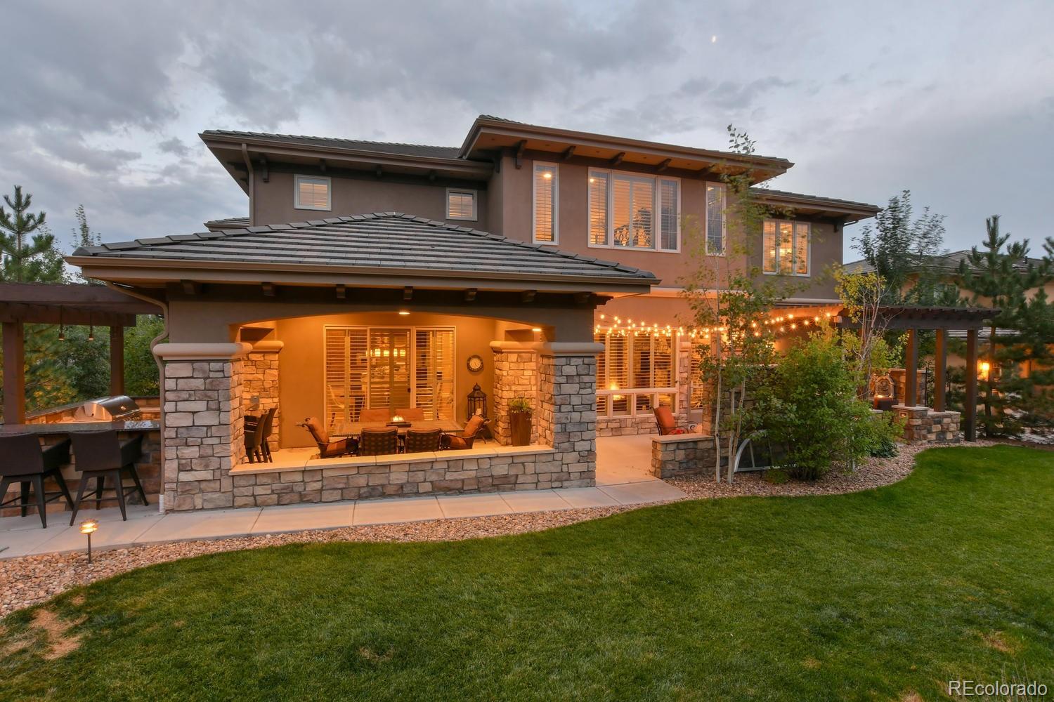 981 Buffalo Ridge Road Castle Pines, CO 80108 - Photo 36 of 39 a front view of a house with garden