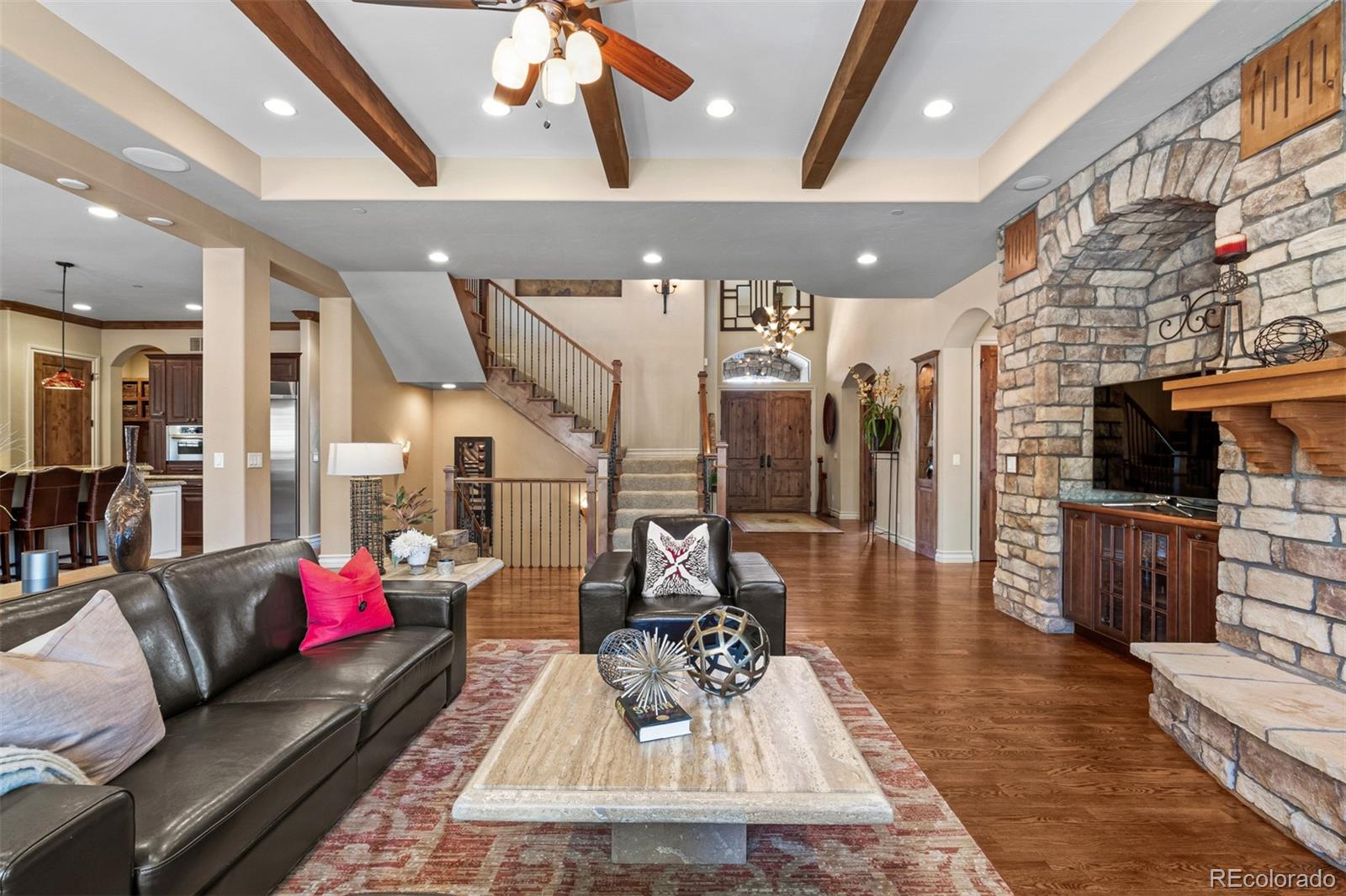 981 Buffalo Ridge Road Castle Pines, CO 80108 - Photo 5 of 39 a living room with furniture and a fireplace