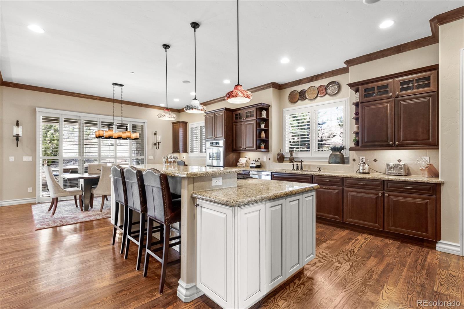 981 Buffalo Ridge Road Castle Pines, CO 80108 - Photo 6 of 39 a kitchen with center island and stainless steel appliances