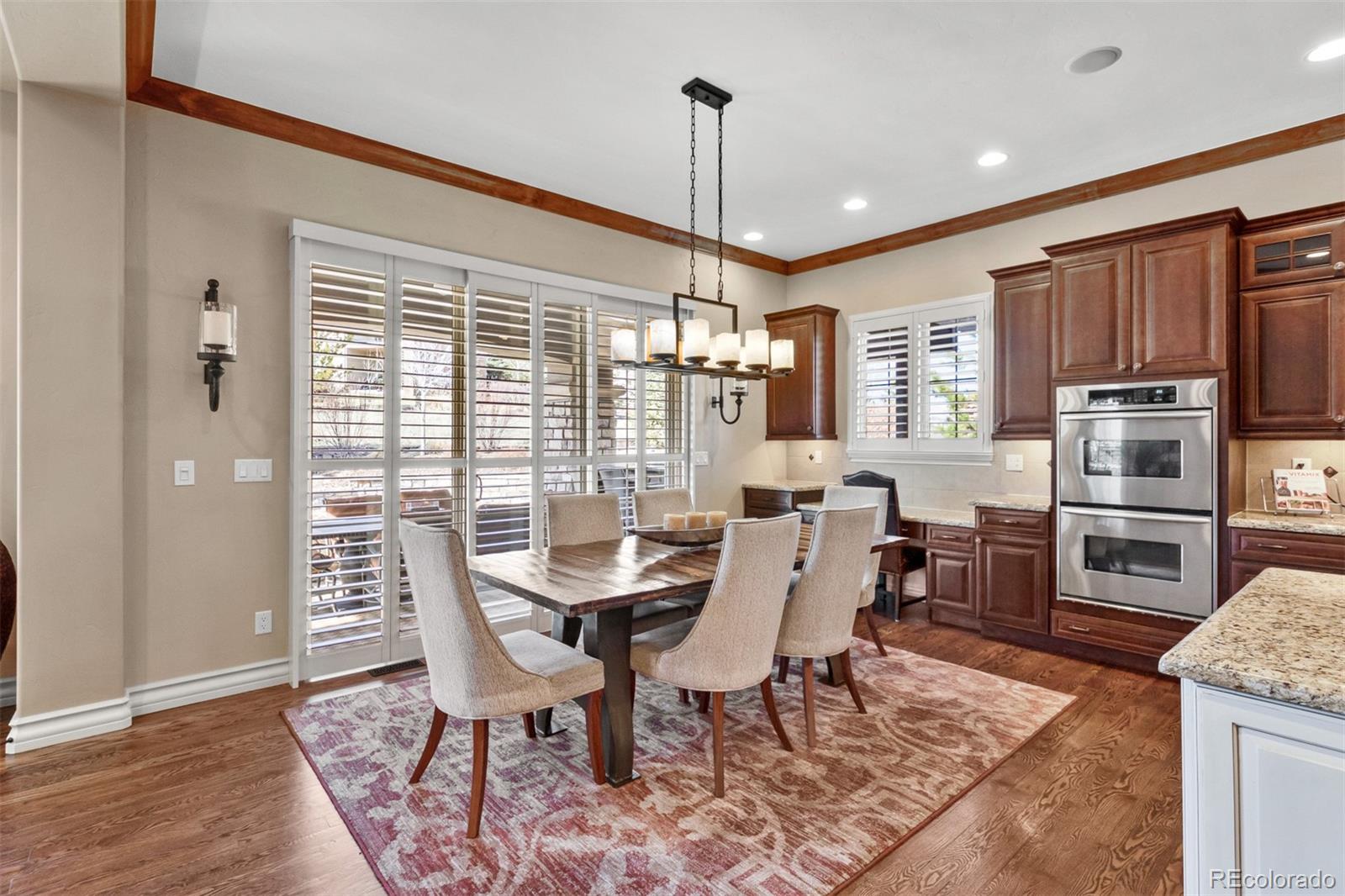 981 Buffalo Ridge Road Castle Pines, CO 80108 - Photo 8 of 39 a view of a dining room with furniture window and wooden floor