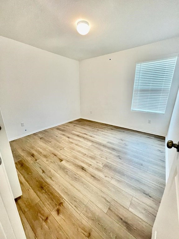 437 Perfect World Loop Jarrell, TX 76537 - Photo 14 of 17 a view of a room with wooden floor