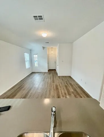 a view of a room with wooden floor