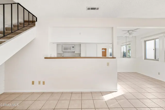 a view of a livingroom with wooden cabinets