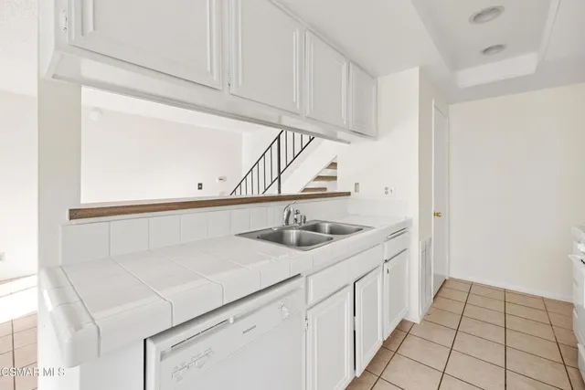 a kitchen with a sink and cabinets