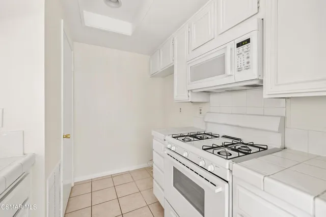 a kitchen with cabinets and appliances