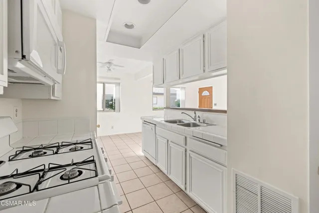 a kitchen with stainless steel appliances granite countertop a stove and a refrigerator