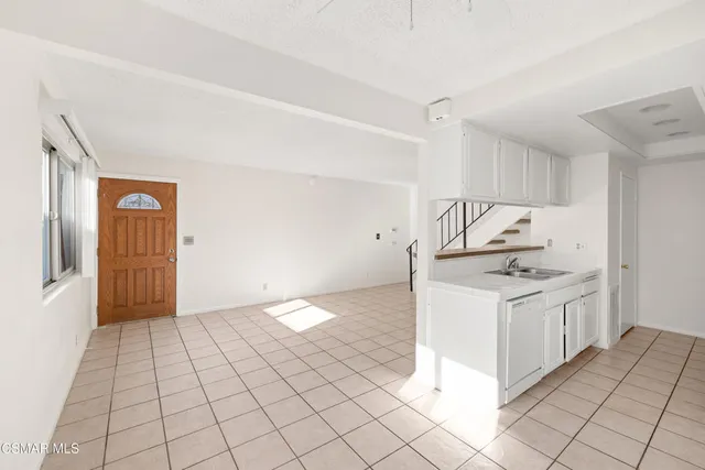 a kitchen with granite countertop white cabinets and white appliances