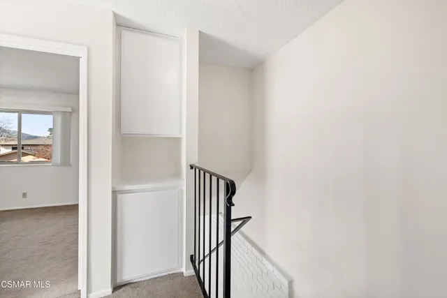 a view of a hallway with wooden floor and entryway
