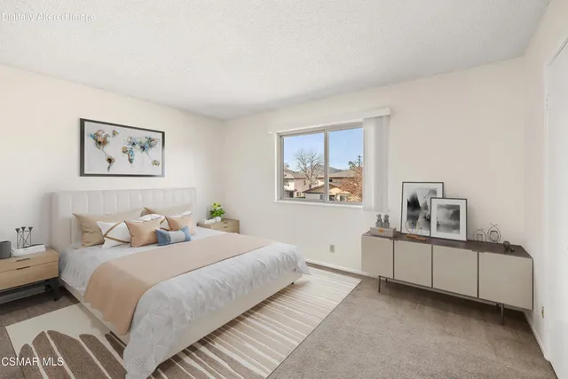 a bedroom with a bed and a view of bedroom