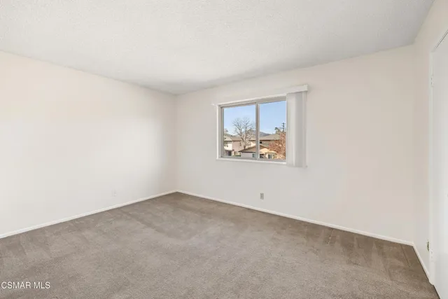 an empty room with a painting on the wall