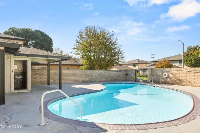 a view of a swimming pool with an outdoor seating