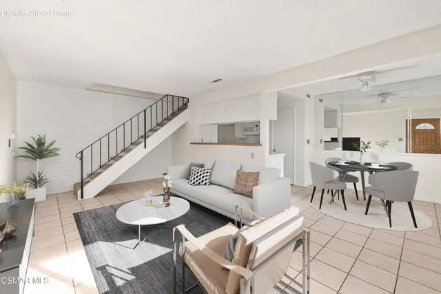 a living room with furniture kitchen view and a dining table
