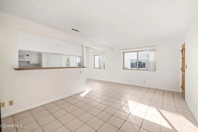 a view of a livingroom with wooden floor and cabinet
