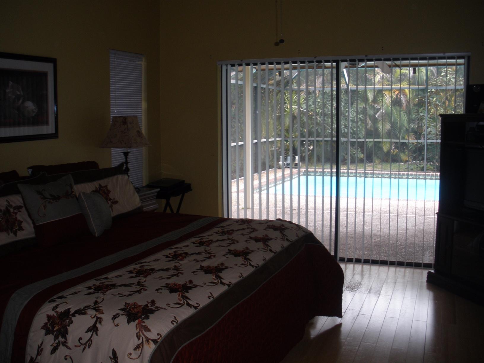 21293 Purple Sage Lane Boca Raton, FL 33428 - Photo 7 of 10 a bedroom with a bed and wooden floor