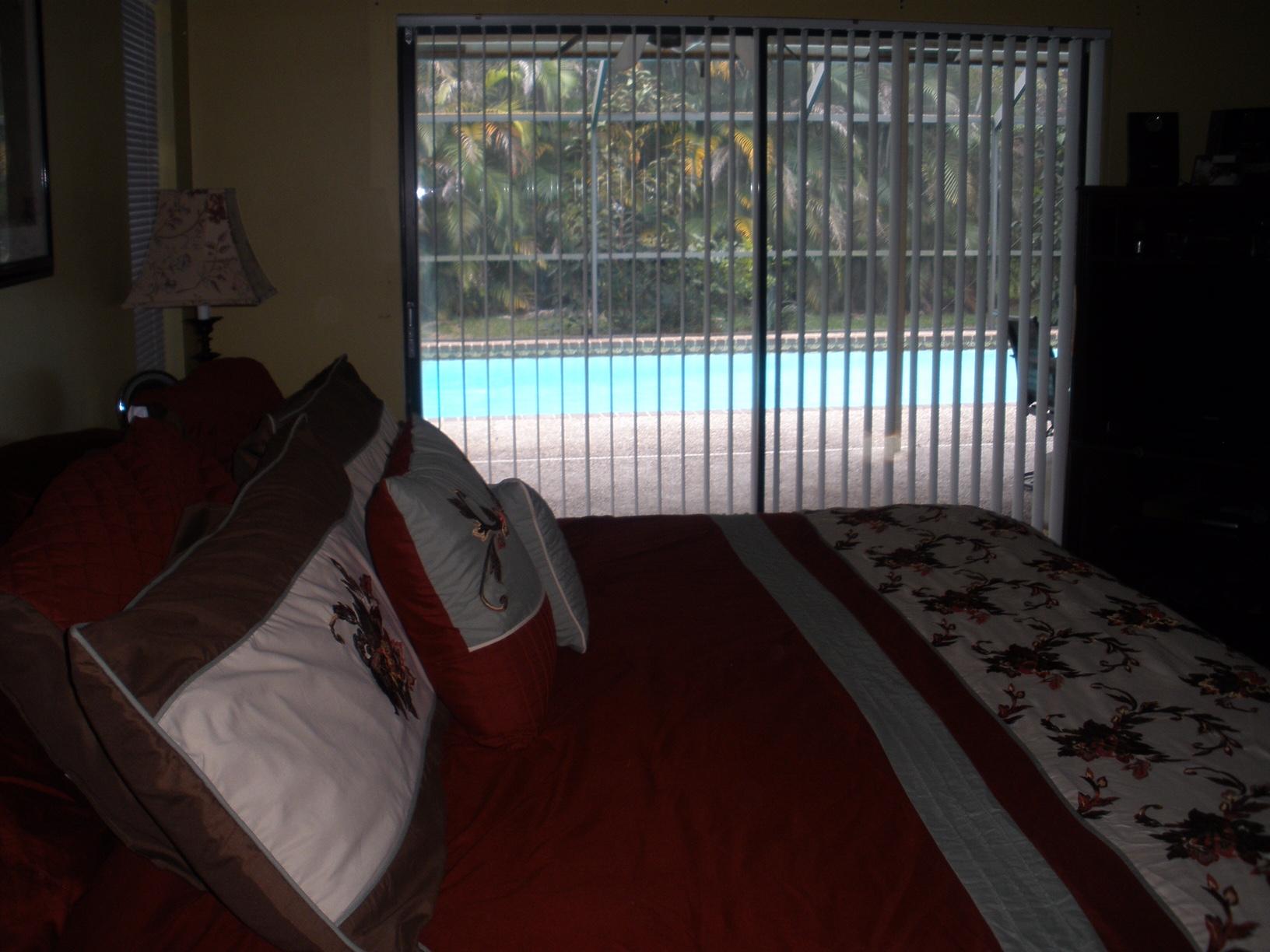 21293 Purple Sage Lane Boca Raton, FL 33428 - Photo 8 of 10 a bed sitting in a bedroom next to a window