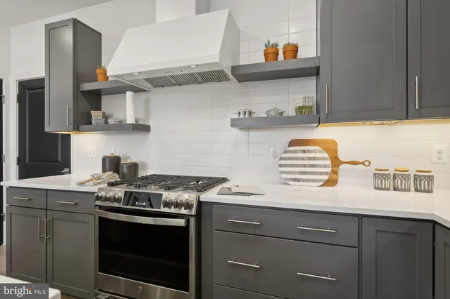 a kitchen with stainless steel appliances granite countertop a stove and a sink
