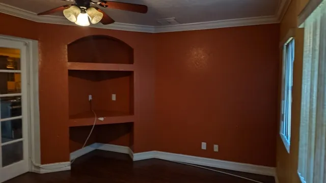 a view of hall way with mirror and window