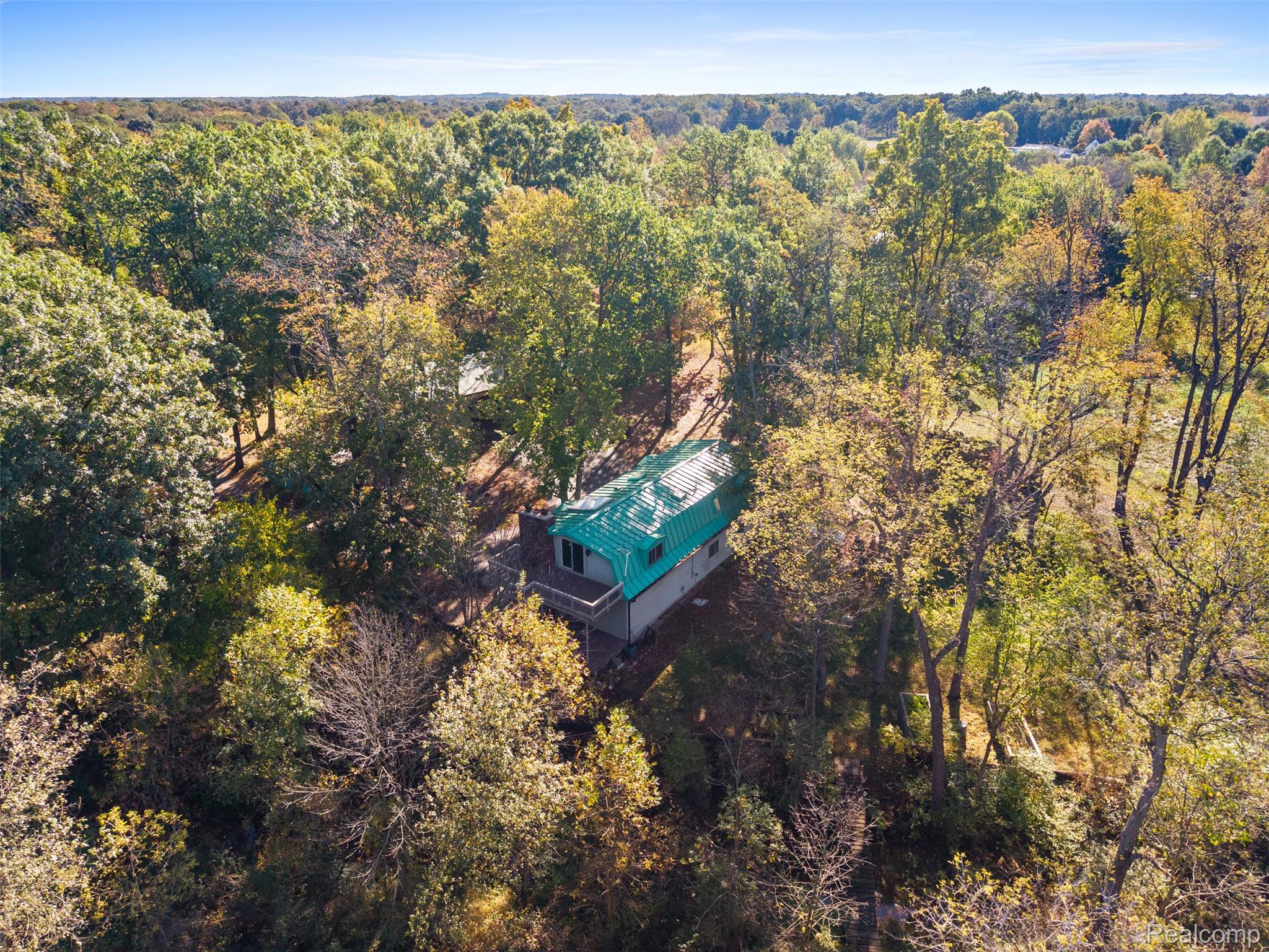 7670 Mi State Road Manchester, MI 48158 - Photo 49 of 53 Aerial view of property and surrounding area with a forest