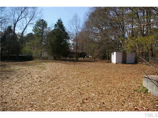 911 Shepard School Road Zebulon, NC 27597 - Photo 3 of 7 Large fenced back yard with storage building.