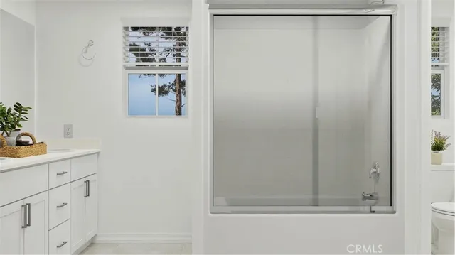 a bathroom with a shower and a sink