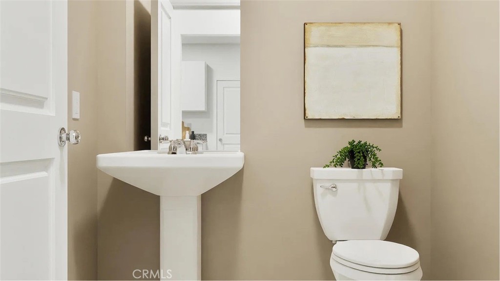 1214 Yeager Avenue Rialto, CA 92376 - Photo 14 of 21 a bathroom with a toilet sink and mirror