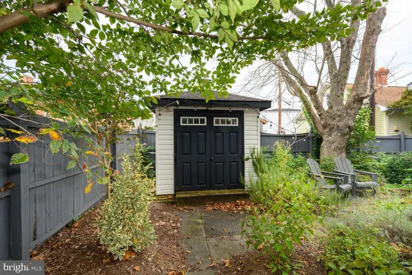 a front view of a house with a tree