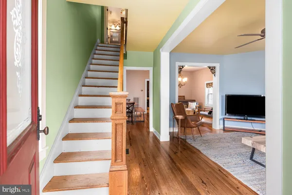 a view of a living room and dining room with wooden floor