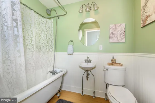 a bathroom with a sink mirror bathtub and toilet