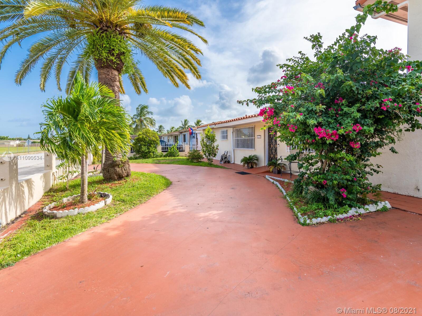2820 Southwest 95th Avenue Miami, FL 33165 - Photo 13 of 100 a front view of a house with a yard and a garage