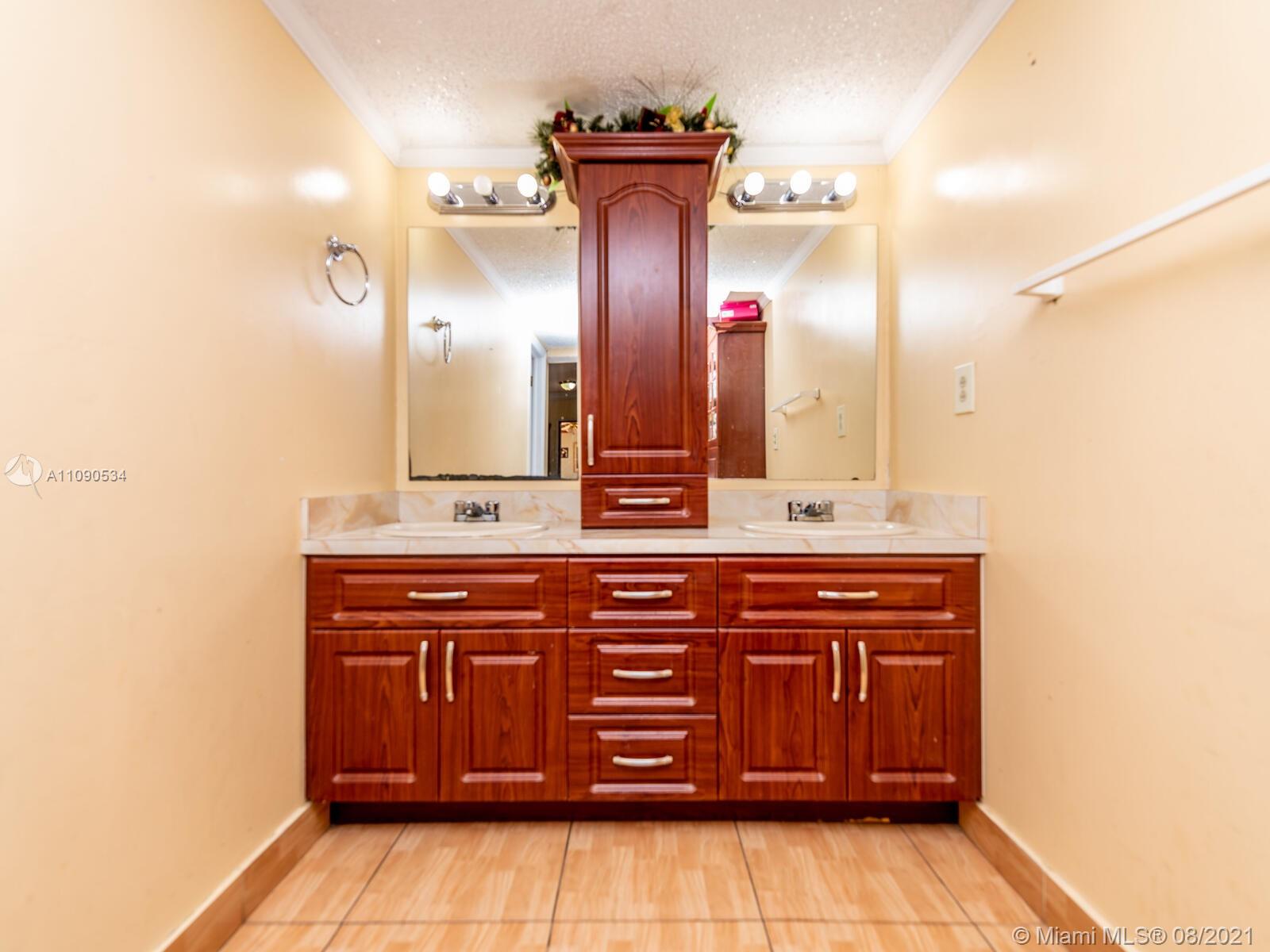 2820 Southwest 95th Avenue Miami, FL 33165 - Photo 40 of 100 a bathroom with a sink and a mirror