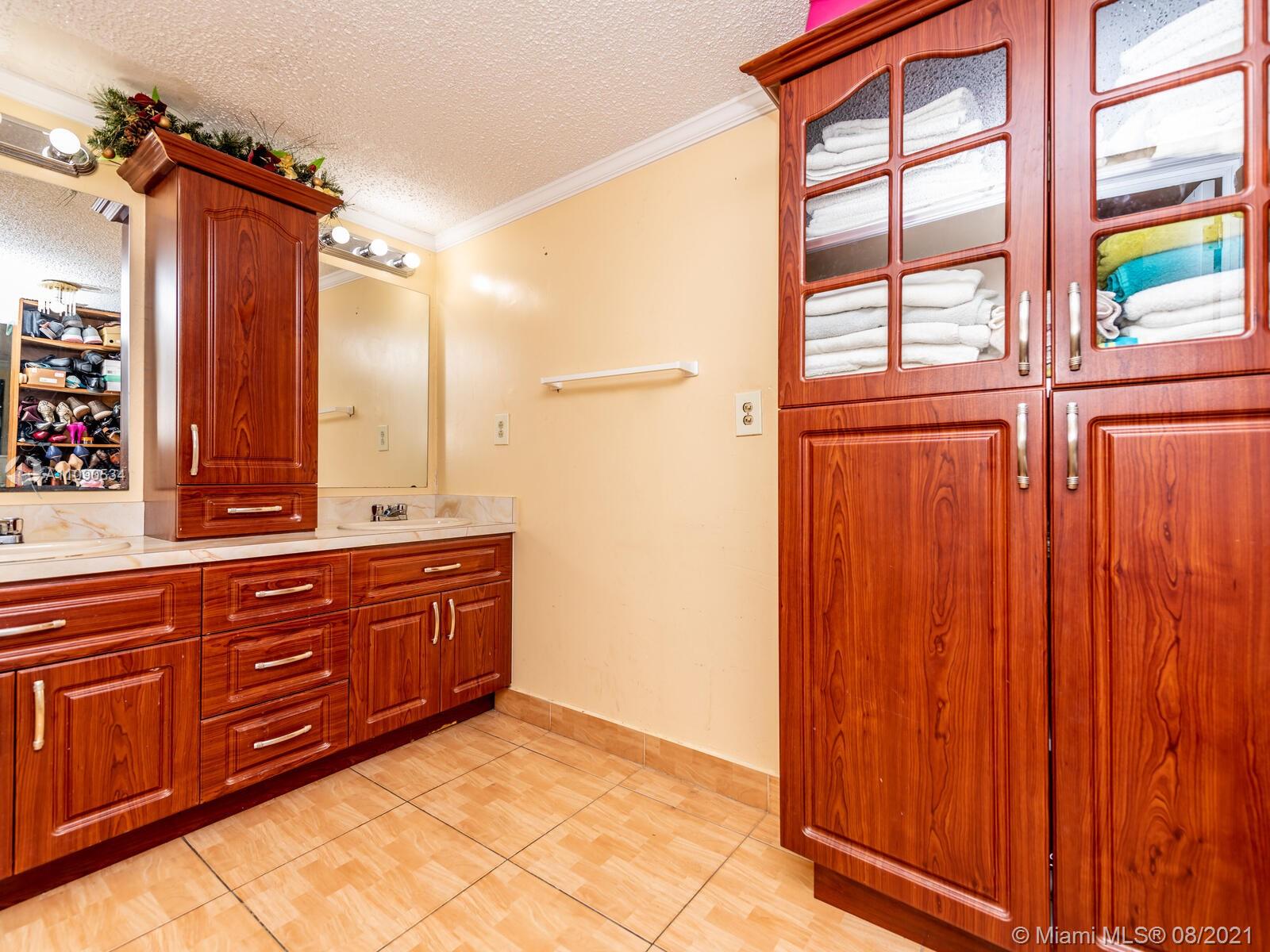 2820 Southwest 95th Avenue Miami, FL 33165 - Photo 41 of 100 a bathroom with a sink and a large mirror