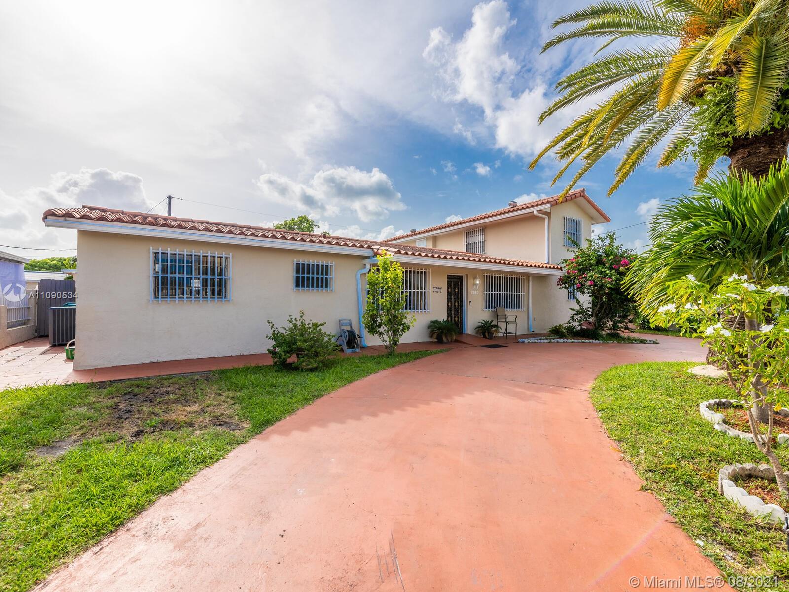 2820 Southwest 95th Avenue Miami, FL 33165 - Photo 7 of 100 a front view of a house with a garden and plants