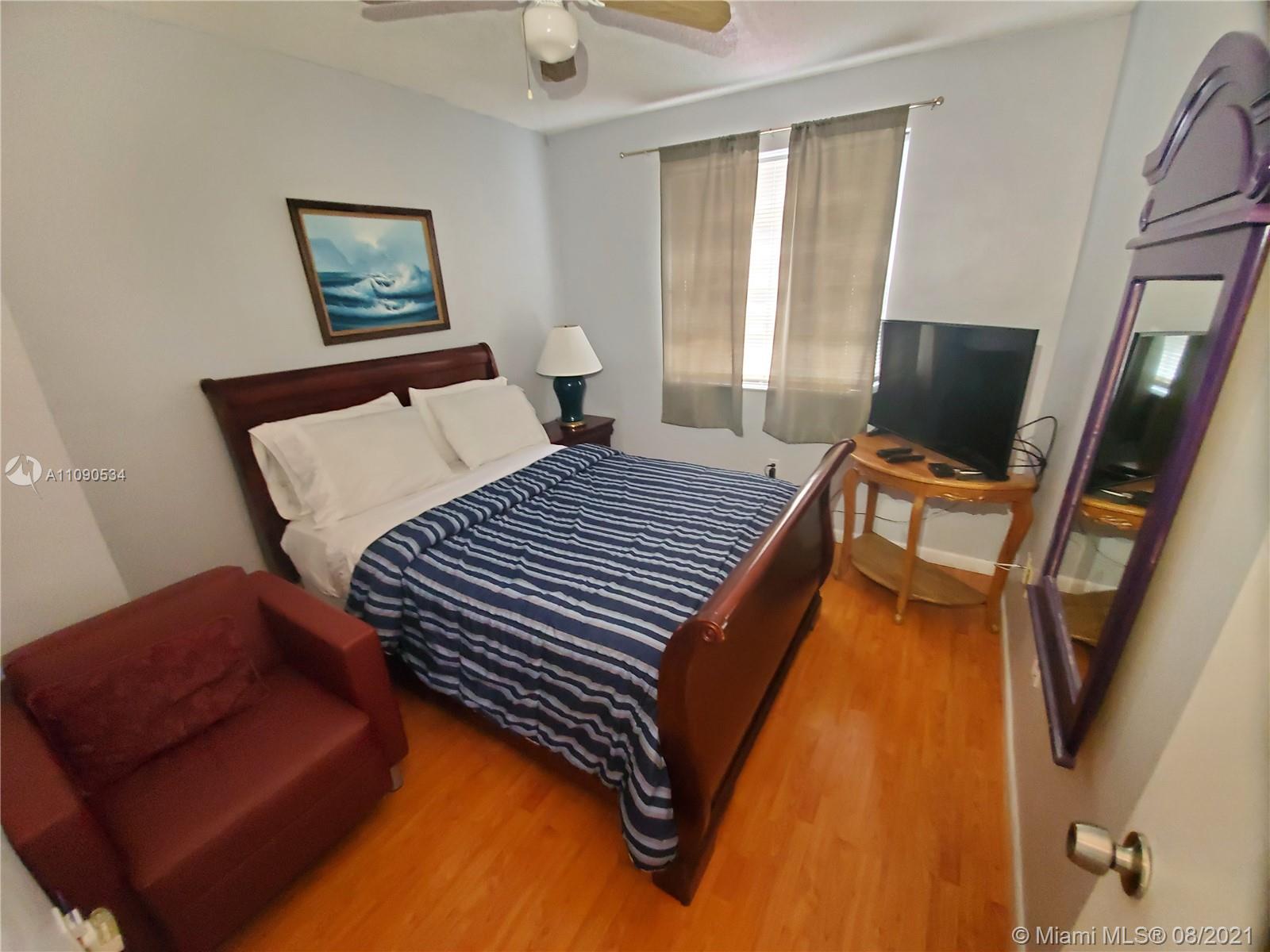 2820 Southwest 95th Avenue Miami, FL 33165 - Photo 89 of 100 a bedroom with a bed and wooden floor