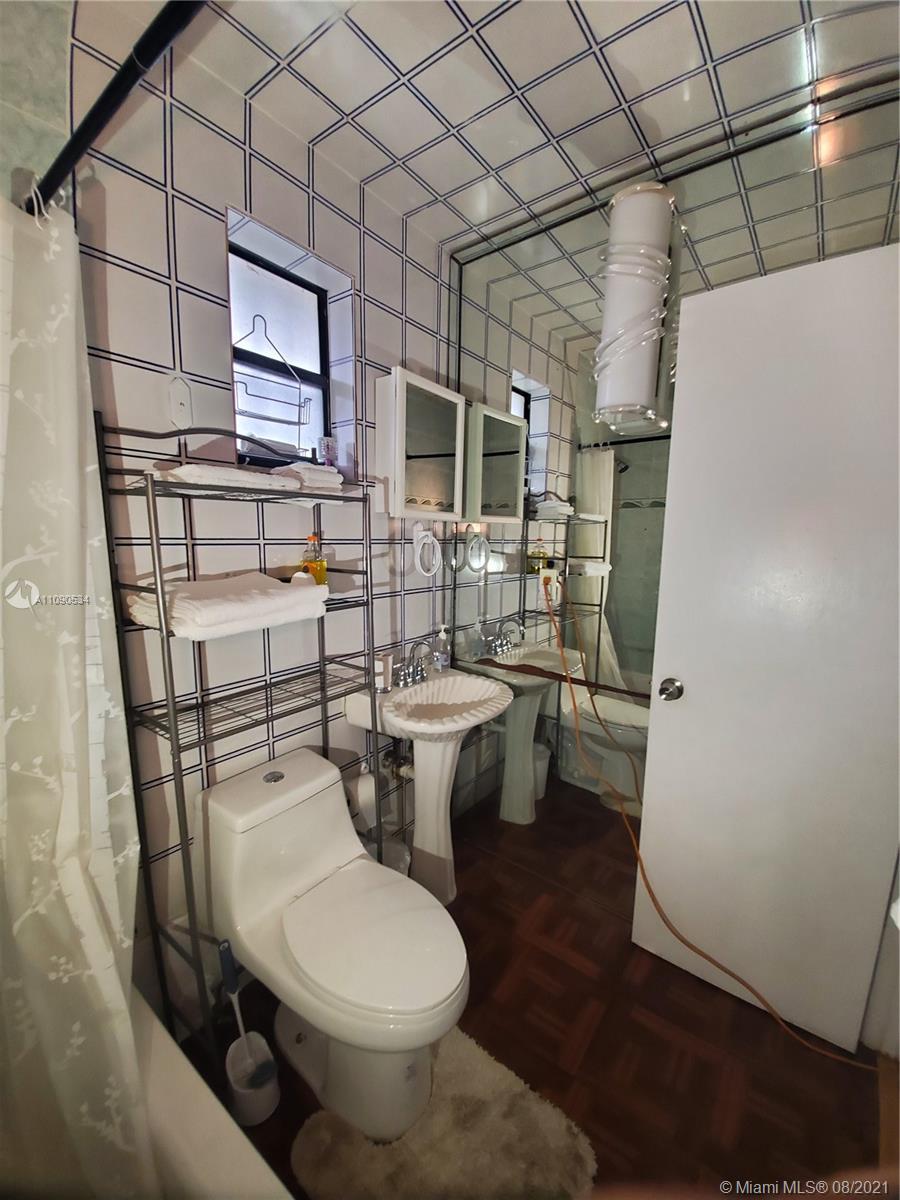 2820 Southwest 95th Avenue Miami, FL 33165 - Photo 97 of 100 a bathroom with a toilet a sink and a mirror