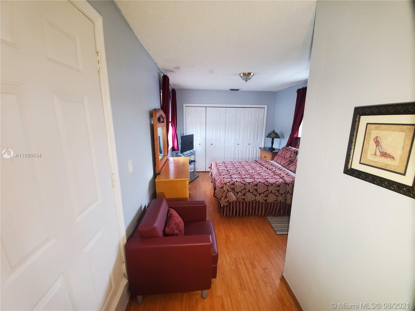 2820 Southwest 95th Avenue Miami, FL 33165 - Photo 98 of 100 a bedroom with furniture and wooden floor