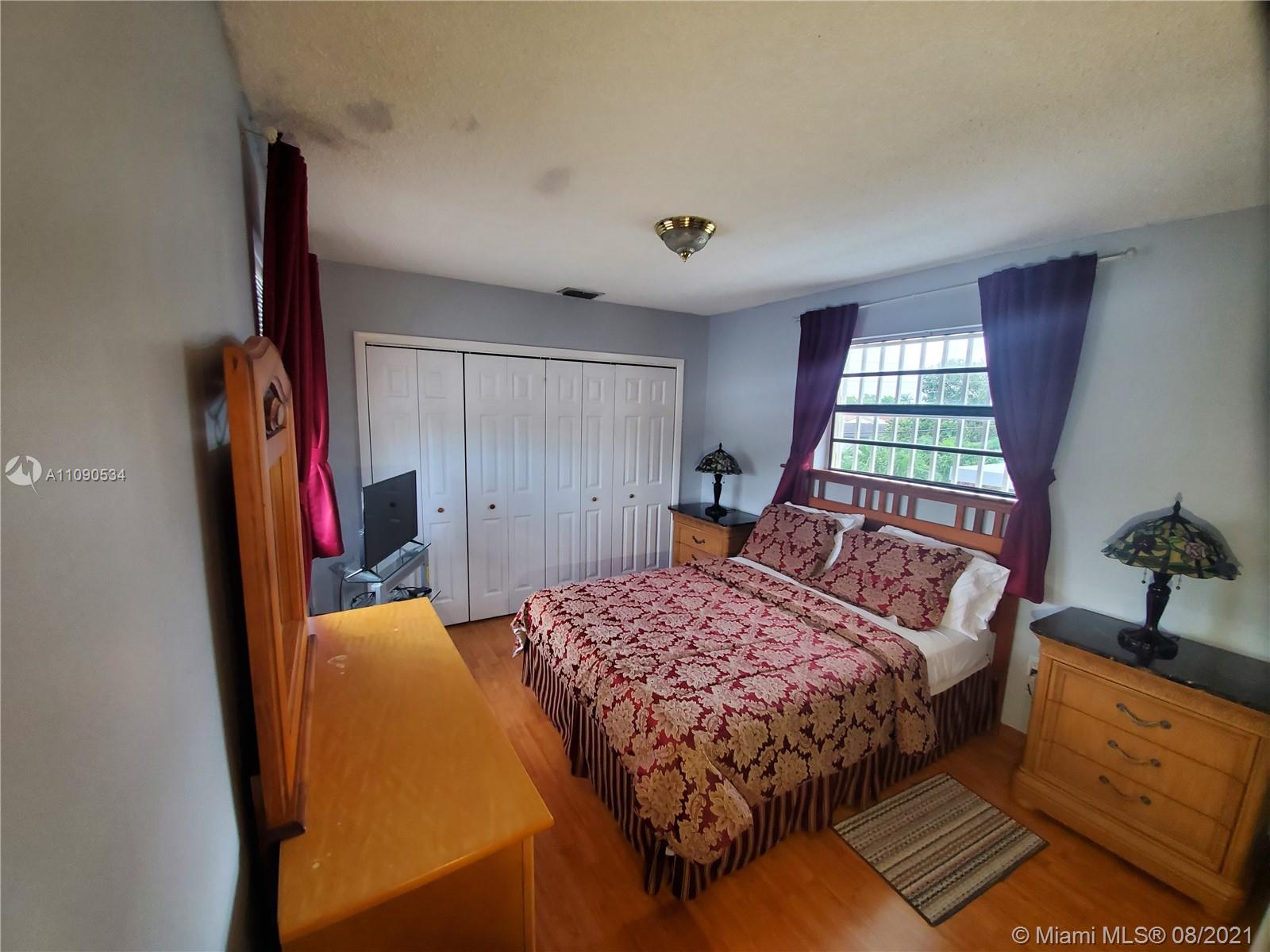 2820 Southwest 95th Avenue Miami, FL 33165 - Photo 99 of 100 a bedroom with a bed and a dresser next to a window