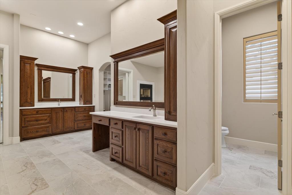 701 West Walcott Street Pilot Point, TX 76258 - Photo 25 of 40 Bathroom with toilet and two vanities
