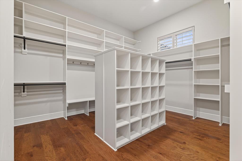 701 West Walcott Street Pilot Point, TX 76258 - Photo 27 of 40 Walk in closet featuring dark wood finished floors