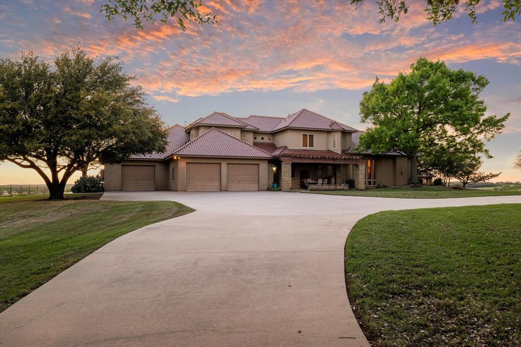 701 West Walcott Street Pilot Point, TX 76258 - Photo 3 of 40 a front view of a house with a garden
