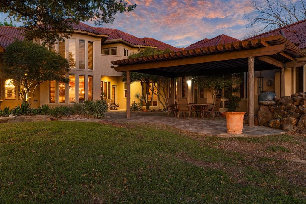 701 West Walcott Street Pilot Point, TX 76258 - Photo 4 of 40 a view of a patio with table and chairs and potted plants
