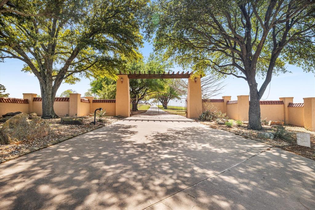 701 West Walcott Street Pilot Point, TX 76258 - Photo 5 of 40 a view of a yard with a tree