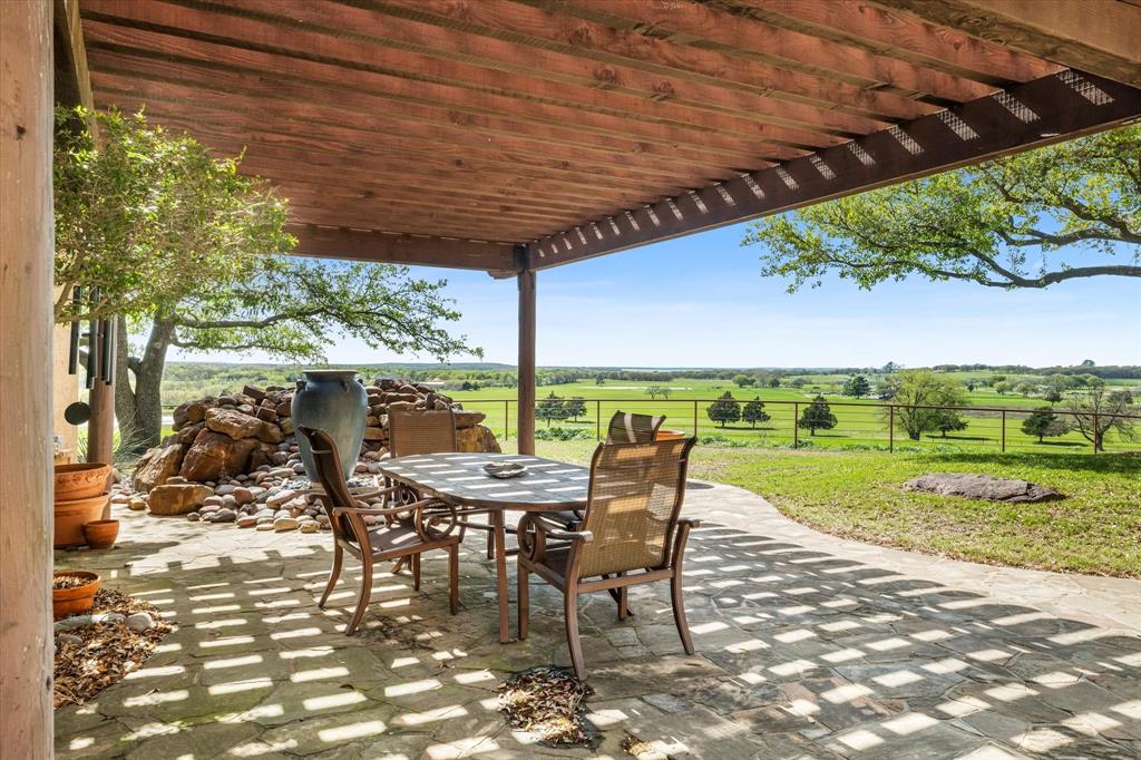 701 West Walcott Street Pilot Point, TX 76258 - Photo 9 of 40 a view of a patio with a table chairs and a patio