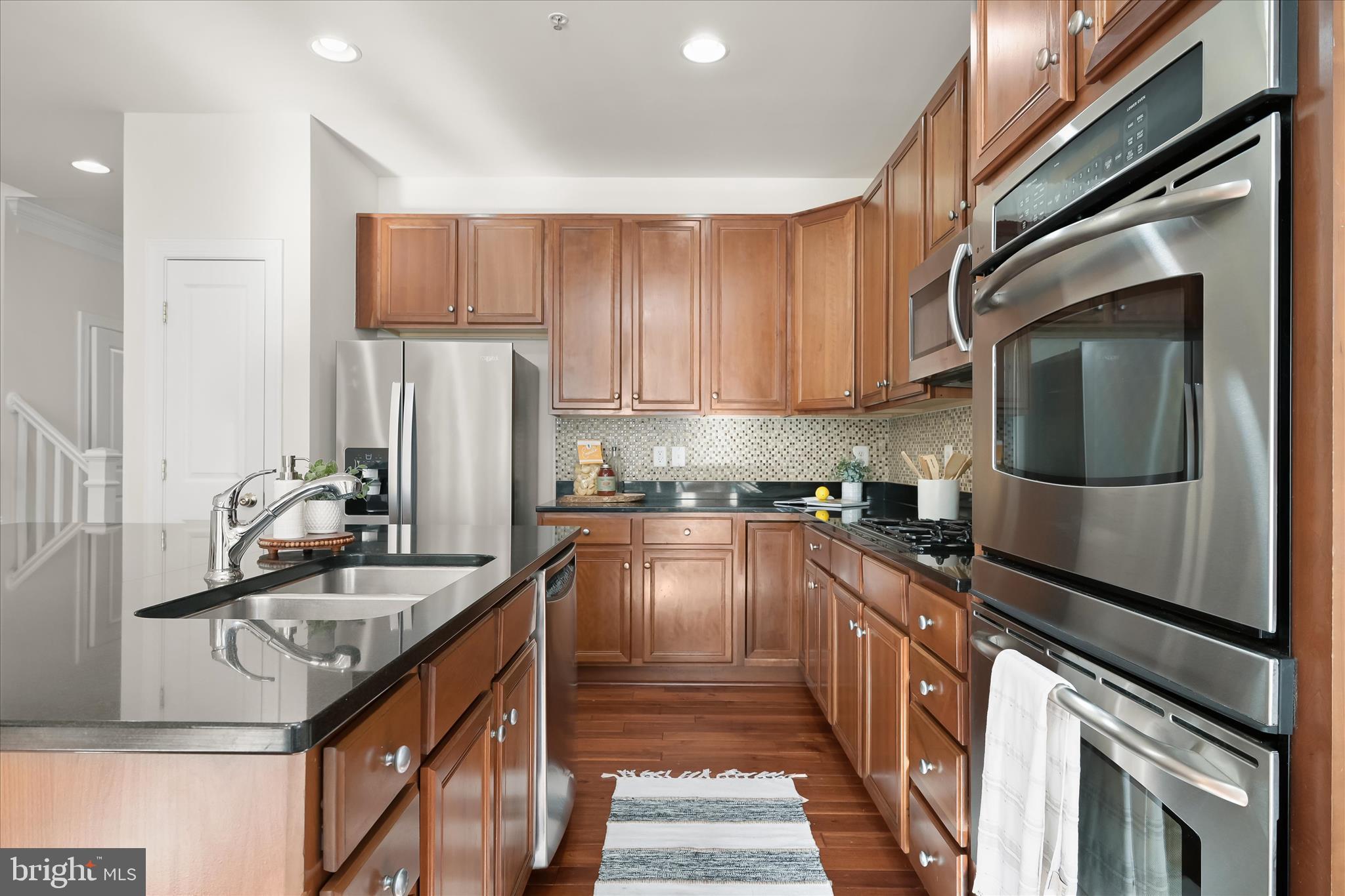 11419 Iager Boulevard Fulton, MD 20759 - Photo 12 of 58 a kitchen with granite countertop a sink stainless steel appliances and cabinets