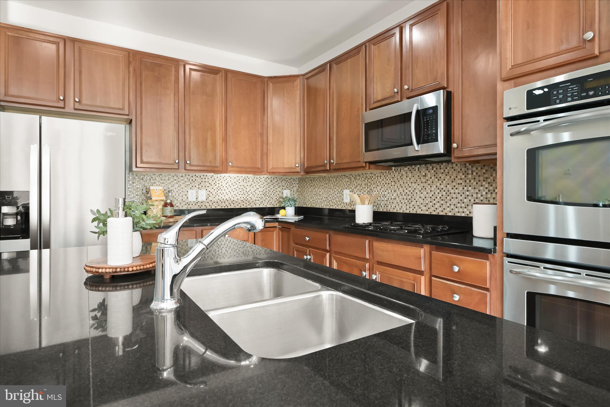 11419 Iager Boulevard Fulton, MD 20759 - Photo 15 of 58 a kitchen with stainless steel appliances granite countertop a refrigerator stove top oven and sink