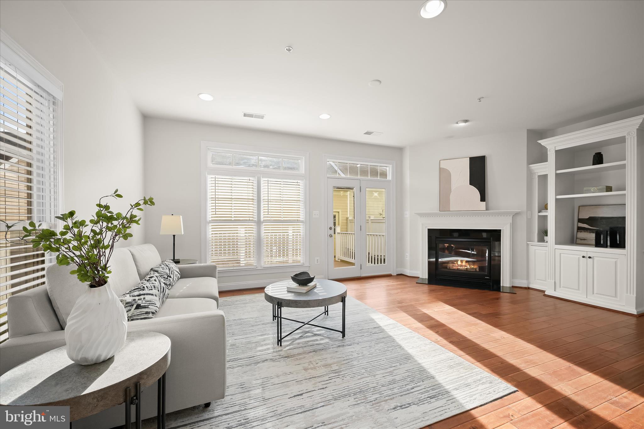 11419 Iager Boulevard Fulton, MD 20759 - Photo 17 of 58 a living room with furniture a fireplace and a table