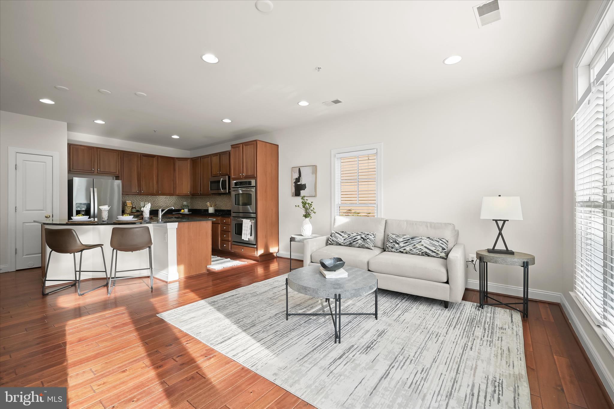 11419 Iager Boulevard Fulton, MD 20759 - Photo 22 of 58 a living room with furniture and kitchen view with wooden floor