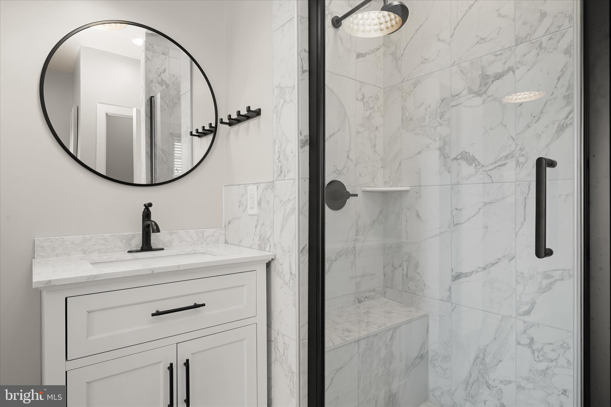 11419 Iager Boulevard Fulton, MD 20759 - Photo 32 of 58 a bathroom with a sink a mirror a vanity and a shower