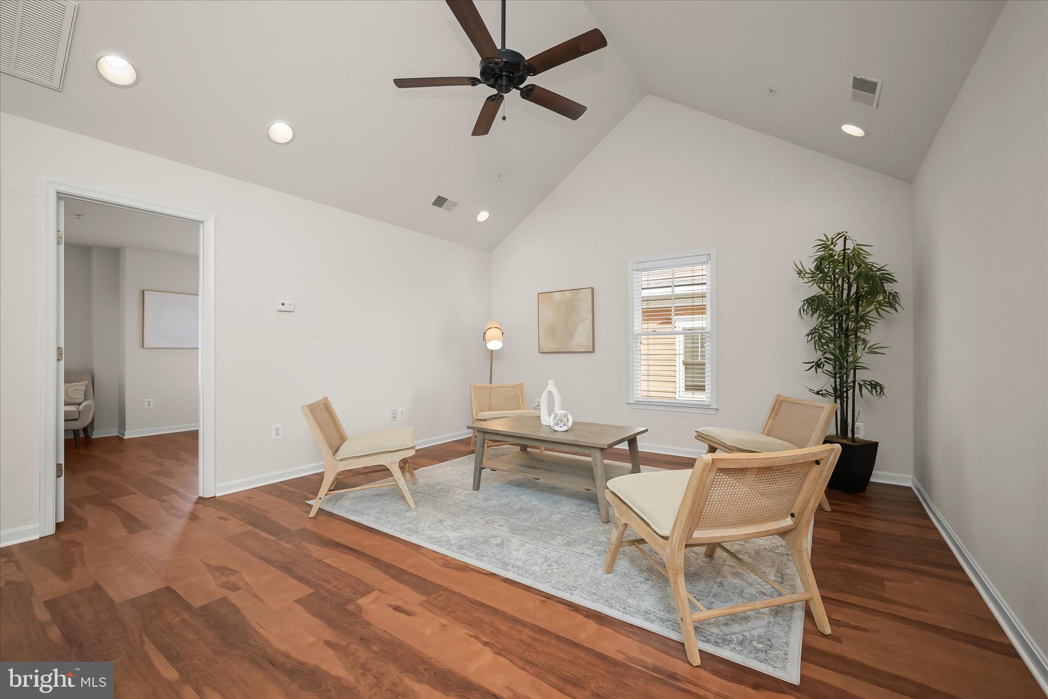 11419 Iager Boulevard Fulton, MD 20759 - Photo 42 of 58 a dining room with wooden floor and a potted plant