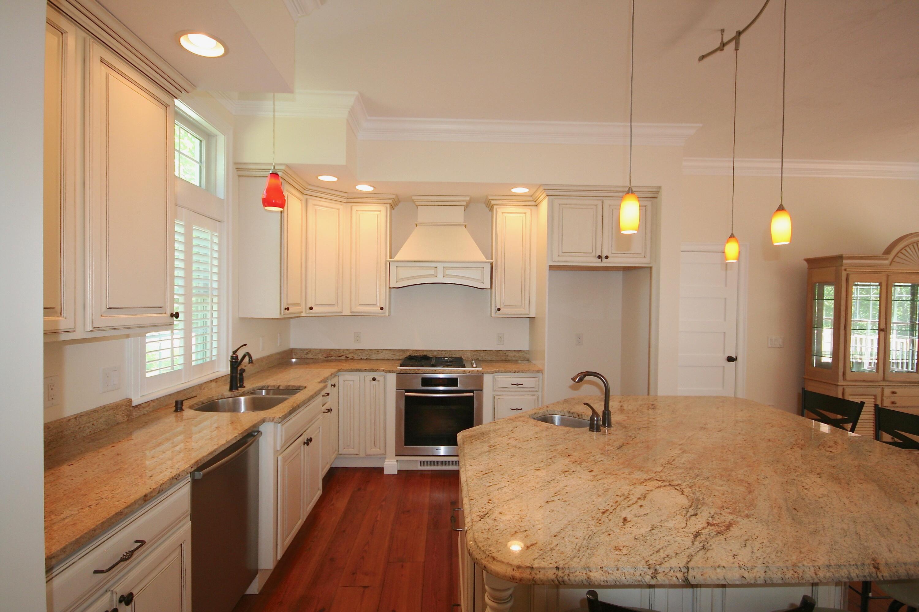 5 Point Road Mashpee, MA 02649 - Photo 12 of 29 a large kitchen with kitchen island a stove a sink a center island and windows